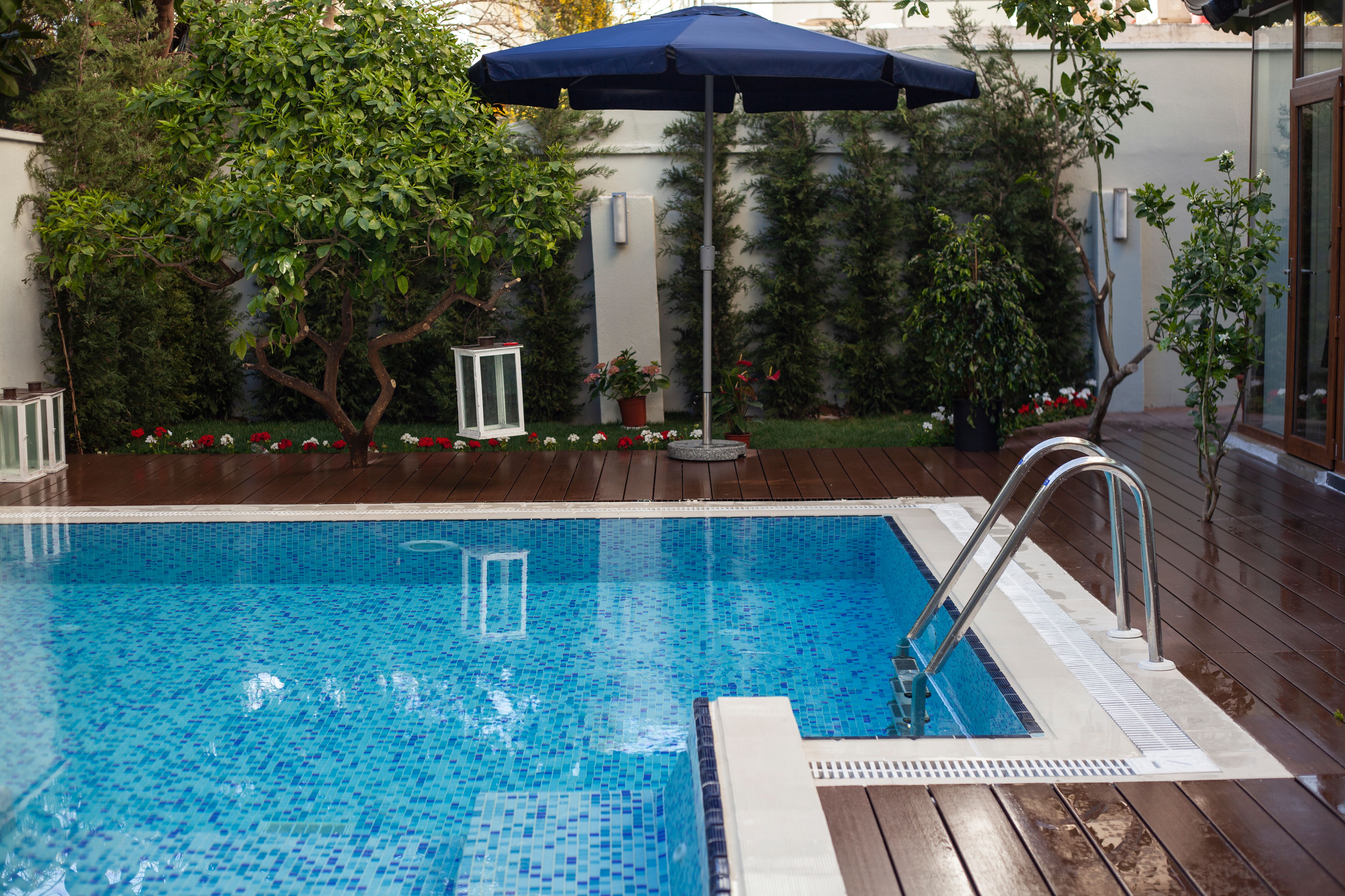 Backyard swimming pool with navy-blue umbrella